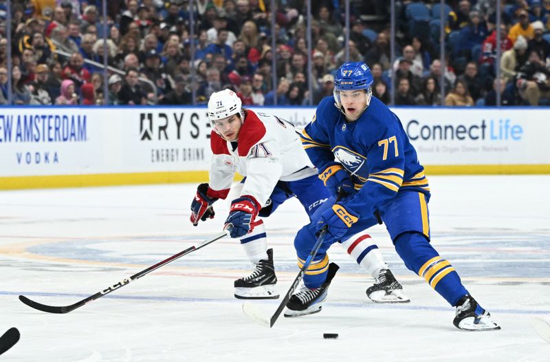 Nov 11, 2024; Buffalo, New York, USA; Buffalo Sabres right wing JJ Peterka (77) handles the puck as Montreal Canadiens center Jake Evans (71) gives chase in the second period at KeyBank Center. Mandatory Credit: Mark Konezny-Imagn Images