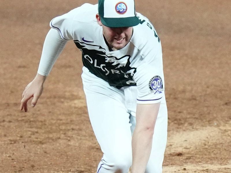 Aug 19, 2023; Denver, Colorado, USA; Colorado Rockies third baseman Ryan McMahon (24) fields the ball in the seventh inning against the Chicago White Sox at Coors Field. Mandatory Credit: Ron Chenoy-USA TODAY Sports