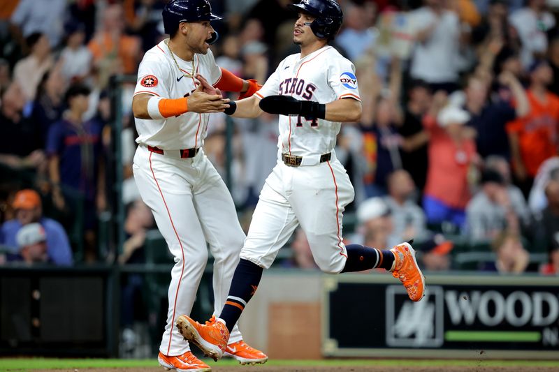 May 22, 2025; Houston, Texas, USA; Houston Astros second baseman Mauricio Dubon (14) is congratulated after scoring a run against the Seattle Mariners during the fourth inning at Daikin Park. Mandatory Credit: Erik Williams-Imagn Images