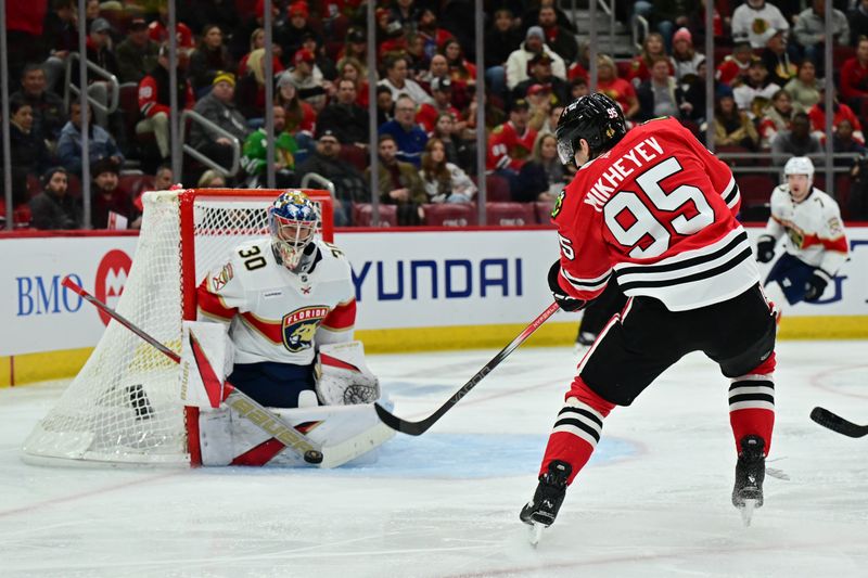 Nov 21, 2024; Chicago, Illinois, USA; Florida Panthers goaltender Spencer Knight (30) saves a shot from Chicago Blackhawks right wing Ilya Mikheyev (95) during the second period at the United Center. Mandatory Credit: Daniel Bartel-Imagn Images