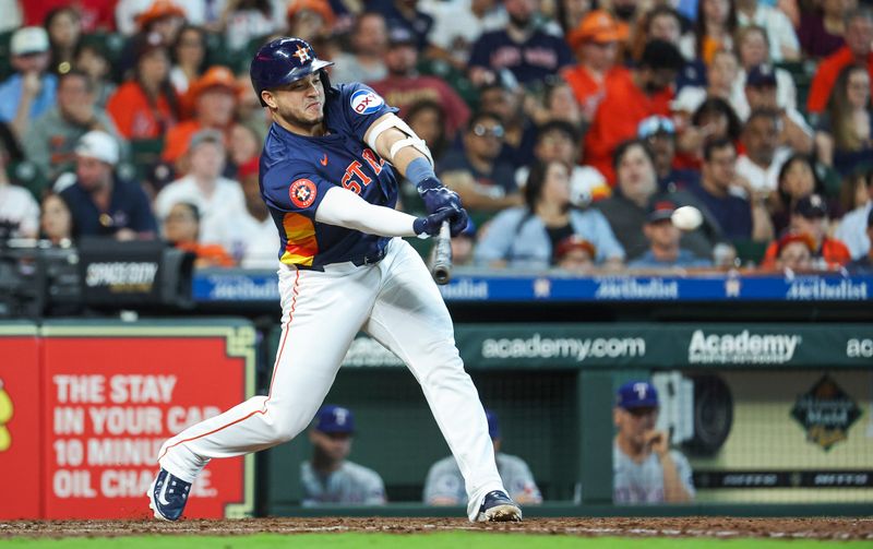 Apr 14, 2024; Houston, Texas, USA; Houston Astros designated hitter Yainer Diaz (21) hits a single during the fifth inning against the Texas Rangers at Minute Maid Park. Mandatory Credit: Troy Taormina-USA TODAY Sports