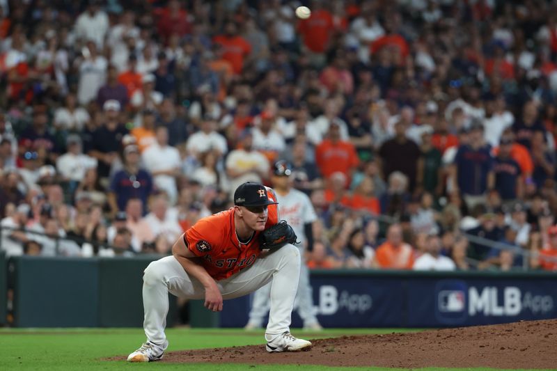 Oct 2, 2024; Houston, Texas, USA; Houston Astros pitcher Hunter Brown (58) drops down as a throw to second base goes over his head as Detroit Tigers shortstop Trey Sweeney (not pictured) steals second during the fifth inning of game two of the Wildcard round for the 2024 MLB Playoffs at Minute Maid Park. Mandatory Credit: Thomas Shea-Imagn Images