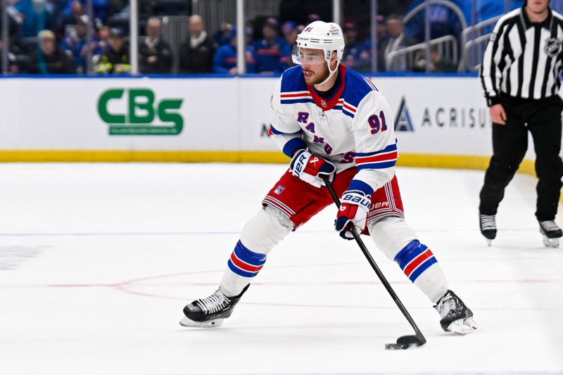 Feb 25, 2025; Elmont, New York, USA;  New York Rangers right wing Reilly Smith (91) looks to pass against the New York Islanders during the third period at UBS Arena. Mandatory Credit: Dennis Schneidler-Imagn Images