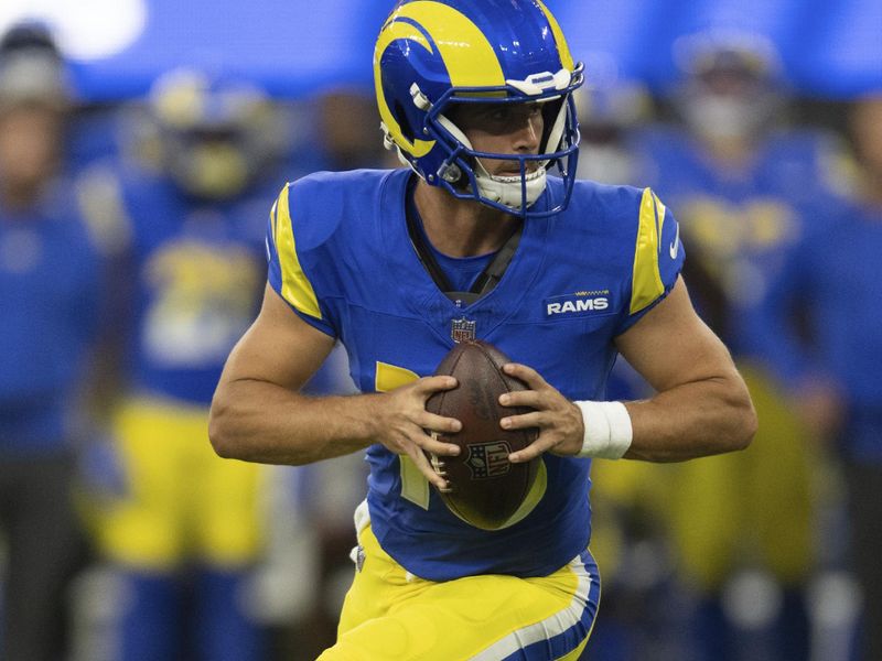 Los Angeles Rams quarterback Stetson Bennett (13) runs with the ball during an NFL preseason football game against the Los Angeles Chargers, Saturday, Aug. 12, 2023, in Inglewood, Calif. (AP Photo/Kyusung Gong)