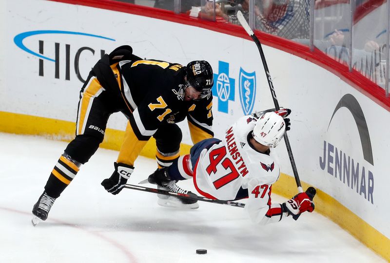 Mar 7, 2024; Pittsburgh, Pennsylvania, USA; Pittsburgh Penguins center Evgeni Malkin (71) commits a tripping penalty against Washington Capitals left wing Beck Malenstyn (47) during the third period at PPG Paints Arena. The Capitals shutout the Penguins 6-0. Mandatory Credit: Charles LeClaire-USA TODAY Sports