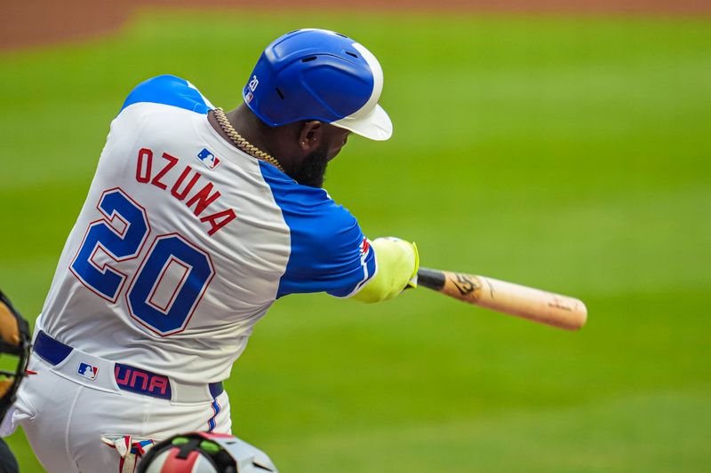 Jul 6, 2024; Cumberland, Georgia, USA; Atlanta Braves designated hitter Marcell Ozuna (20) hits a two run home run against the Philadelphia Phillies during the first inning at Truist Park. Mandatory Credit: Dale Zanine-USA TODAY Sports