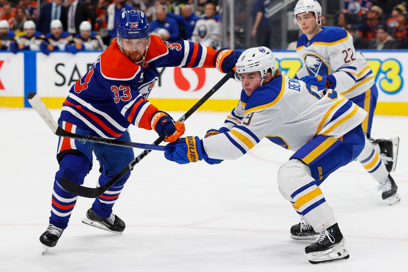 Jan 25, 2025; Edmonton, Alberta, CAN; Edmonton Oilers forward Victor Arvidsson (33) and Buffalo Sabres forward Zach Benson (9) battle for position during the first period at Rogers Place. Mandatory Credit: Perry Nelson-Imagn Images