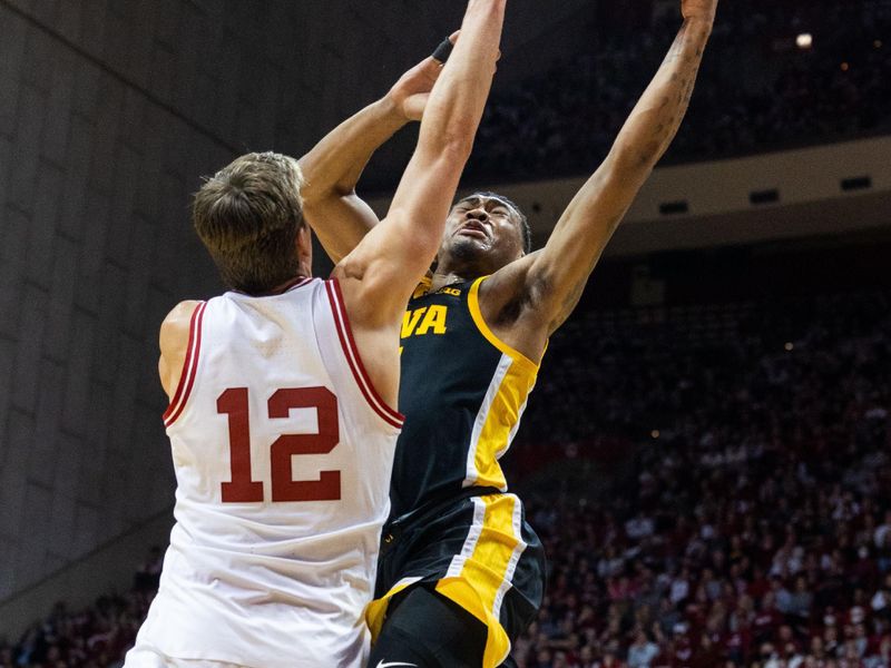 Feb 28, 2023; Bloomington, Indiana, USA; Iowa Hawkeyes guard Tony Perkins (11) shoots the ball while Indiana Hoosiers forward Miller Kopp (12) defends in the second half at Simon Skjodt Assembly Hall. Mandatory Credit: Trevor Ruszkowski-USA TODAY Sports