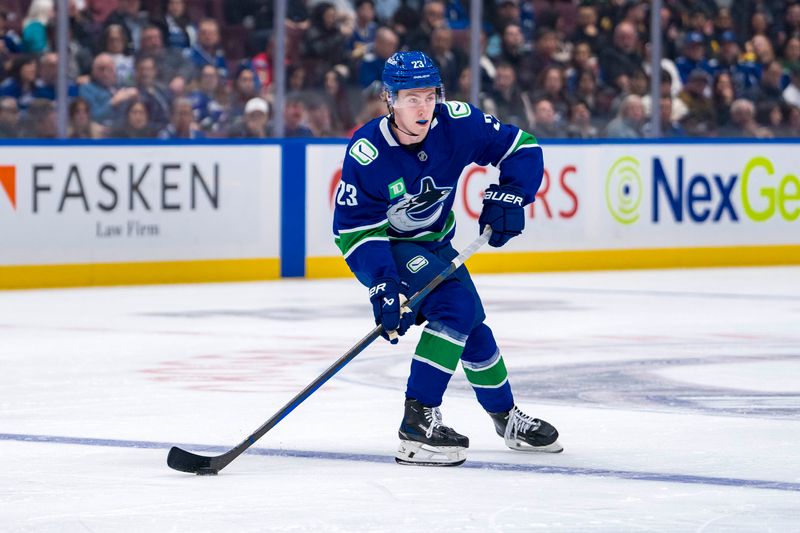 Nov 12, 2024; Vancouver, British Columbia, CAN; Vancouver Canucks forward Jonathan Lekkerimaki (23) handles the puck against the Calgary Flames during the second period at Rogers Arena. Mandatory Credit: Bob Frid-Imagn Images