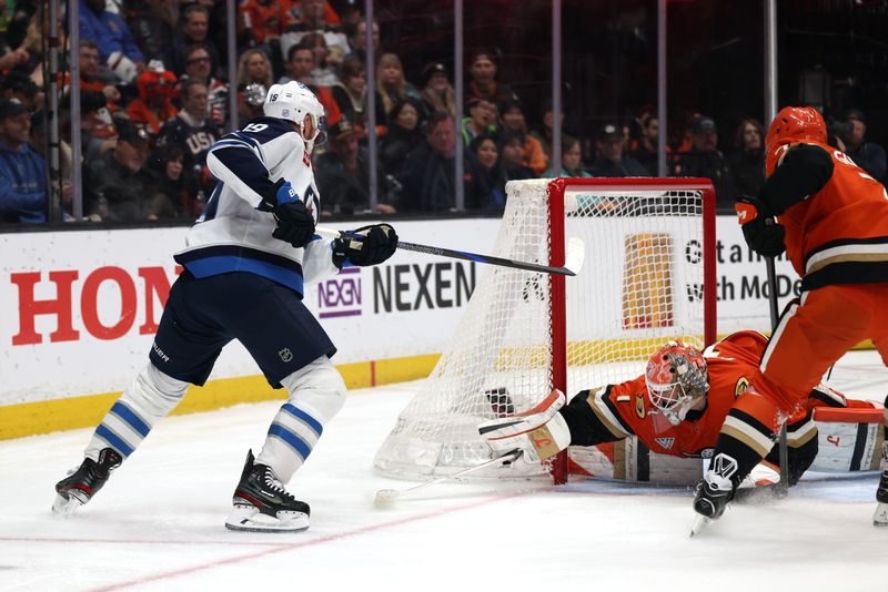 Feb 27, 2026; Anaheim, California, USA;  Anaheim Ducks goaltender Lukas Dostal (1) defends the goal as Winnipeg Jets center Jonathan Toews (19) attacks the goal during the second period at Honda Center. Mandatory Credit: Kiyoshi Mio-Imagn Images