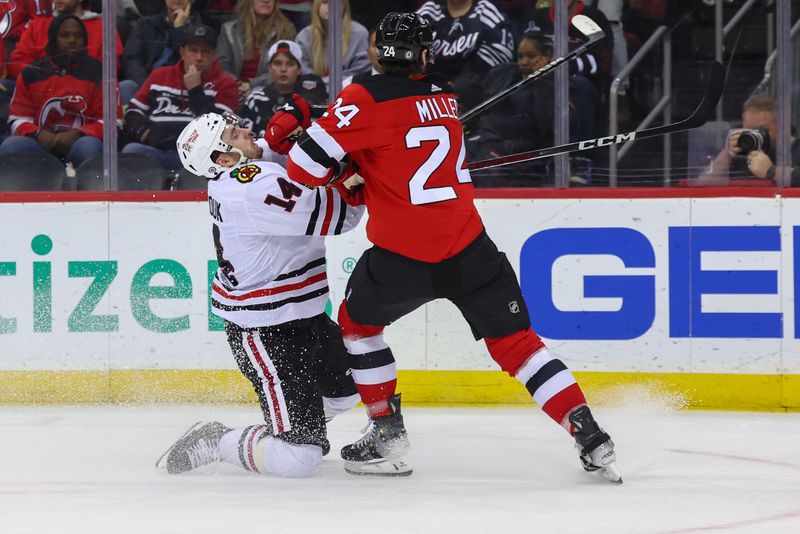 Jan 5, 2024; Newark, New Jersey, USA; New Jersey Devils defenseman Colin Miller (24) hits Chicago Blackhawks left wing Boris Katchouk (14) during the third period at Prudential Center. Mandatory Credit: Ed Mulholland-USA TODAY Sports