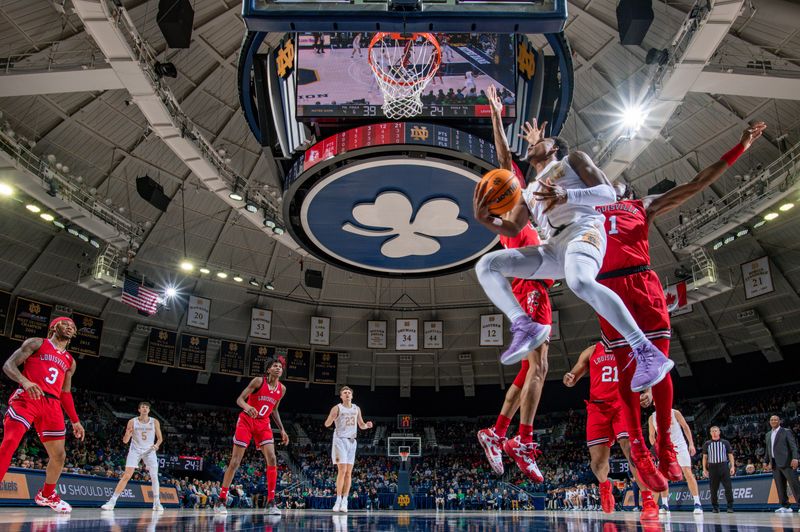 Jan 28, 2023; South Bend, Indiana, USA; Notre Dame Fighting Irish guard JJ Starling (1) shoots the ball against Louisville Cardinals guard Mike James (1) in the first half at the Purcell Pavilion. Mandatory Credit: Matt Cashore-USA TODAY Sports