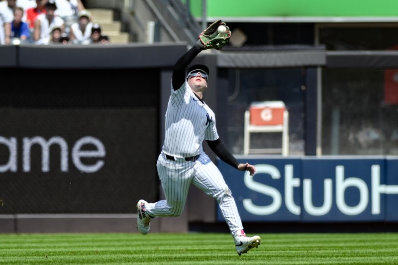 Aug 10, 2024; Bronx, New York, USA; New York Yankees outfielder Alex Verdugo (24) catches a fly ball for an out during the second inning against the Texas Rangers at Yankee Stadium. Mandatory Credit: John Jones-USA TODAY Sports