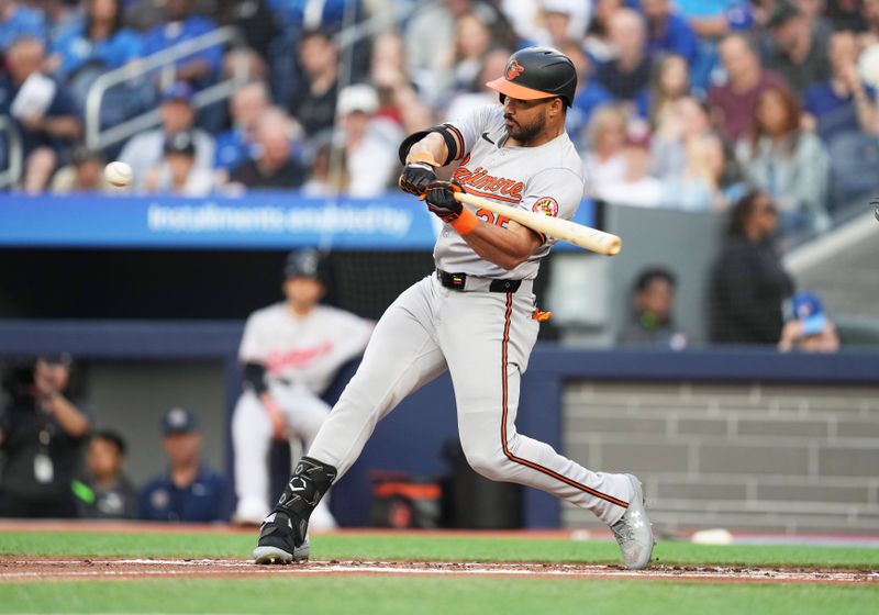 Jun 3, 2024; Toronto, Ontario, CAN; Baltimore Orioles right fielder Anthony Santander (25) hits a two run home run against the Toronto Blue Jays during the second inning at Rogers Centre. Mandatory Credit: Nick Turchiaro-USA TODAY Sports