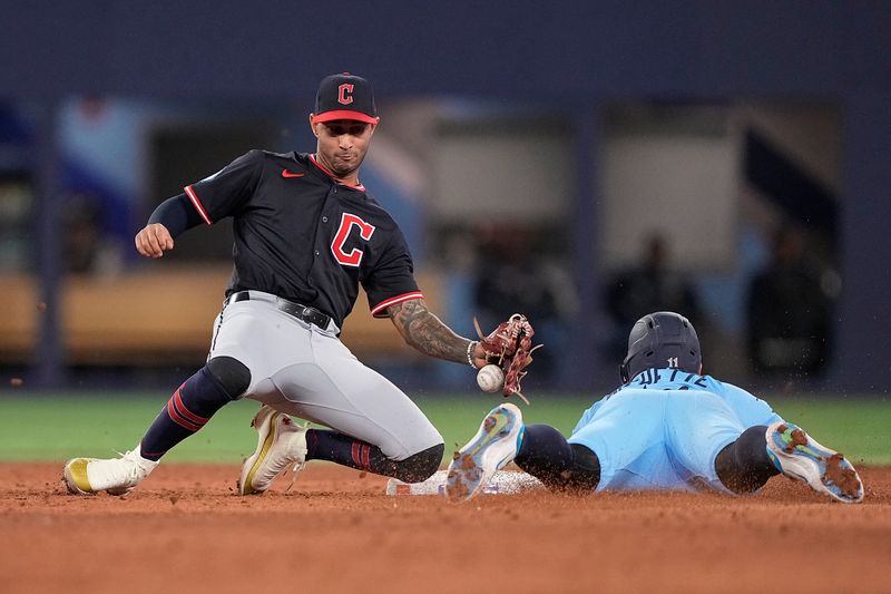 May 4, 2025; Toronto, Ontario, CAN; Toronto Blue Jays shortstop Bo Bichette (11) steals second base as Cleveland Guardians shortstop Brayan Rocchio (4) bobbles the ball during the ninth inning at Rogers Centre. Mandatory Credit: John E. Sokolowski-Imagn Images