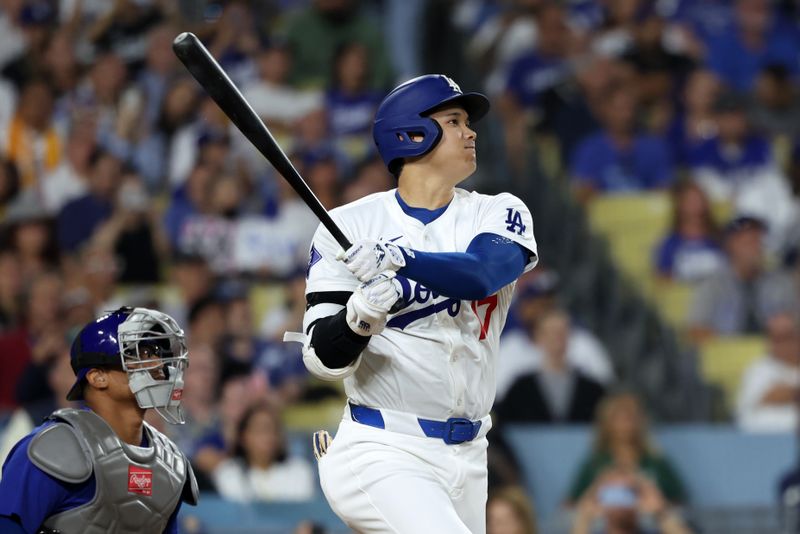 Sep 11, 2024; Los Angeles, California, USA;  Los Angeles Dodgers designated hitter Shohei Ohtani (17) hits a home run during the first inning against the Chicago Cubs at Dodger Stadium. Mandatory Credit: Kiyoshi Mio-Imagn Images