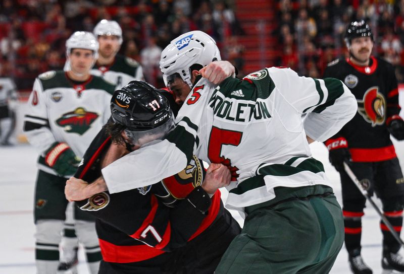 Nov 18, 2023; Stockholm, SWE; Minnesota Wild defenseman Jake Middleton (5) fights with Ottawa Senators center Zack MacEwen (17) during a Global Series NHL hockey game at Avicii Arena. Mandatory Credit: Per Haljestam-USA TODAY Sports