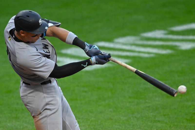 Apr 22, 2025; Cleveland, Ohio, USA; New York Yankees right fielder Aaron Judge (99) hits a double in the fourth inning against the Cleveland Guardians at Progressive Field. Mandatory Credit: David Richard-Imagn Images