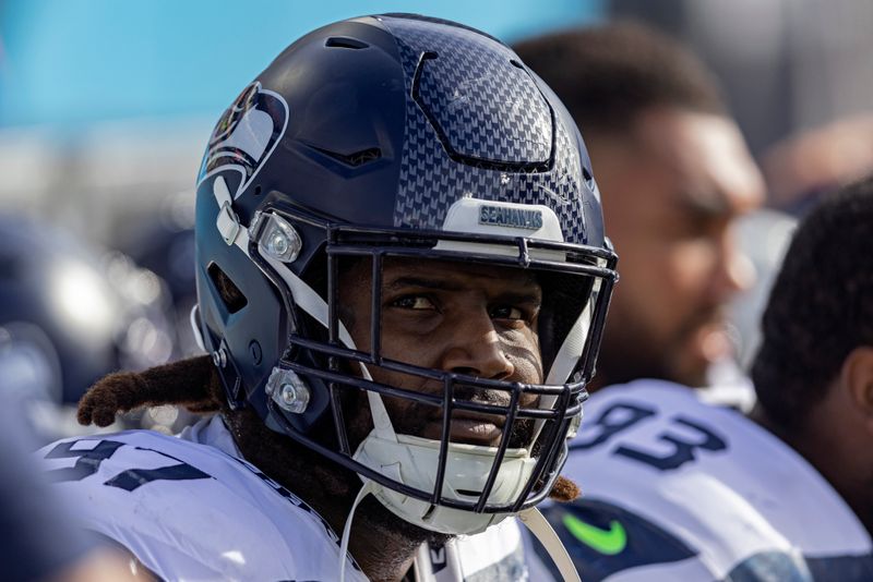 Seattle Seahawks defensive end Mario Edwards Jr. (97) watches a play on the Jumbotron during their NFL football game against the Tennessee Titans Sunday, Dec. 24, 2023, in Nashville, Tenn. (AP Photo/Wade Payne)