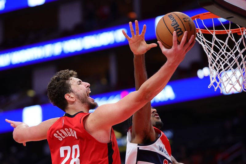 HOUSTON, TEXAS - NOVEMBER 11: Alperen Sengun #28 of the Houston Rockets scores over Alexandre Sarr #20 of the Washington Wizards during the second half at Toyota Center on November 11, 2024 in Houston, Texas. NOTE TO USER: User expressly acknowledges and agrees that, by downloading and or using this photograph, User is consenting to the terms and conditions of the Getty Images License Agreement. (Photo by Alex Slitz/Getty Images)