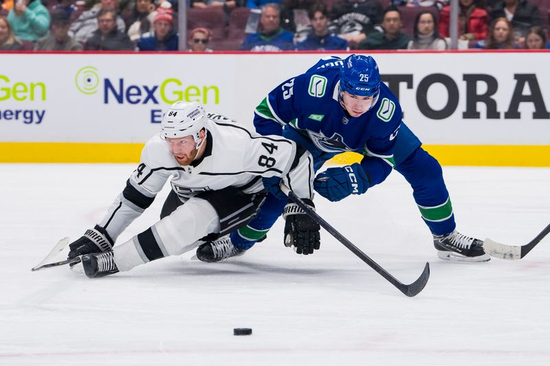 Apr 2, 2023; Vancouver, British Columbia, CAN; Vacnouver Canucks forward Aidan McDonough (25) checks Los Angeles Kings defenseman Vladislav Gavrikov (84) to the ice in the third period at Rogers Arena. Kings won 4-1. Mandatory Credit: Bob Frid-USA TODAY Sports