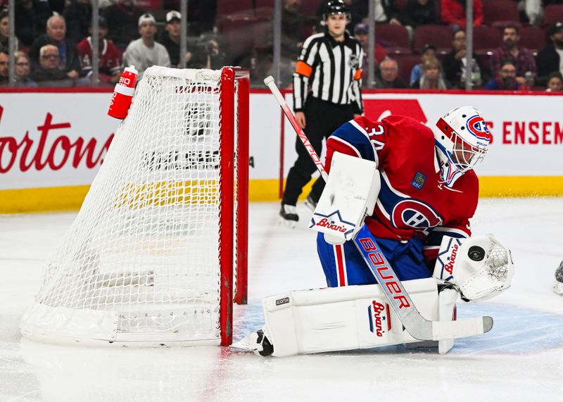 Oct 21, 2023; Montreal, Quebec, CAN; Montreal Canadiens goalie Jake Allen (34) makes a save against the Washington Capitals during the first period at Bell Centre. Mandatory Credit: David Kirouac-USA TODAY Sports