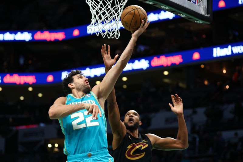 CHARLOTTE, NORTH CAROLINA - MARCH 27: Vasilije Micic #22 of the Charlotte Hornets drives to the basket against Evan Mobley #4 of the Cleveland Cavaliers during the first half of the game at Spectrum Center on March 27, 2024 in Charlotte, North Carolina. NOTE TO USER: User expressly acknowledges and agrees that, by downloading and or using this photograph, User is consenting to the terms and conditions of the Getty Images License Agreement. (Photo by Jared C. Tilton/Getty Images)