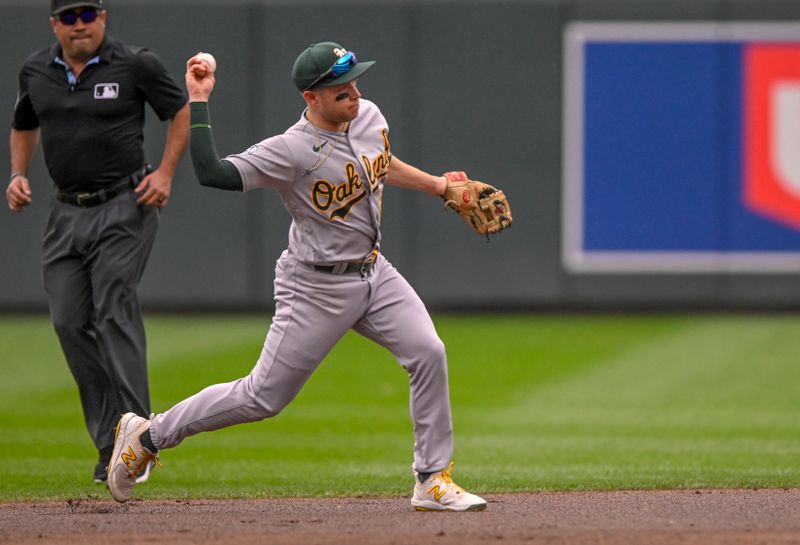 Sep 28, 2023; Minneapolis, Minnesota, USA; Oakland Athletics infielder Nick Allen (2) throws to first base for a force out against the Minnesota Twins during the first inning at Target Field. Mandatory Credit: Nick Wosika-USA TODAY Sports