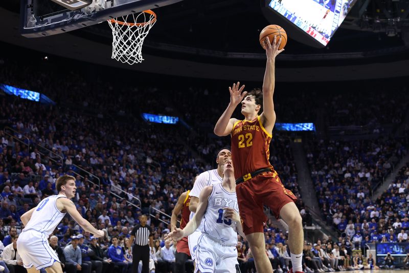 Jan 16, 2024; Provo, Utah, USA; Iowa State Cyclones forward Milan Momcilovic (22) shoots the ball \against Brigham Young Cougars guard Richie Saunders (15) during the second half at Marriott Center. Mandatory Credit: Rob Gray-USA TODAY Sports