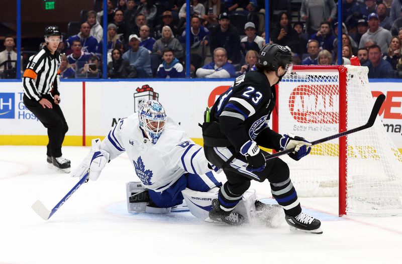 Nov 30, 2024; Tampa, Florida, USA; Tampa Bay Lightning center Michael Eyssimont (23) shoots on Toronto Maple Leafs goaltender Joseph Woll (60) as he makes a save during the first period at Amalie Arena. Mandatory Credit: Kim Klement Neitzel-Imagn Images