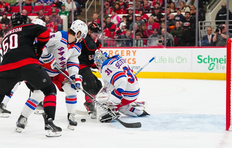 Nov 27, 2024; Raleigh, North Carolina, USA;  New York Rangers goaltender Igor Shesterkin (31) stops the shot by Carolina Hurricanes right wing Jackson Blake (53) during the first period at Lenovo Center. Mandatory Credit: James Guillory-Imagn Images