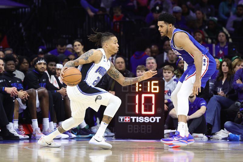 PHILADELPHIA, PENNSYLVANIA - JANUARY 30: Markelle Fultz #20 of the Orlando Magic drives past Tobias Harris #12 of the Philadelphia 76ers during the second quarter at Wells Fargo Center on January 30, 2023 in Philadelphia, Pennsylvania. NOTE TO USER: User expressly acknowledges and agrees that, by downloading and or using this photograph, User is consenting to the terms and conditions of the Getty Images License Agreement. (Photo by Tim Nwachukwu/Getty Images)