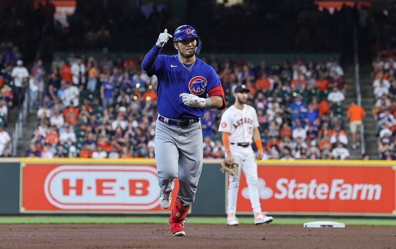 May 17, 2023; Houston, Texas, USA; Houston Astros second baseman David Hensley (17) reacts and Chicago Cubs right fielder Seiya Suzuki (27) rounds the bases after hitting a home run during the first inning at Minute Maid Park. Mandatory Credit: Troy Taormina-USA TODAY Sports