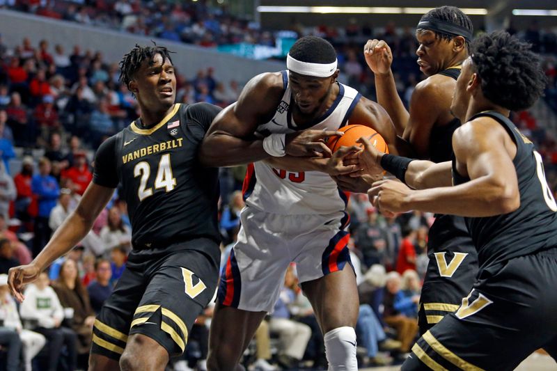 Jan 13, 2024; Oxford, Mississippi, USA; Vanderbilt Commodores forward JaQualon Roberts (24) and forward Ven-Allen Lubin (right) battle Mississippi Rebels forward Moussa Cisse (33) for a rebound during the second half at The Sandy and John Black Pavilion at Ole Miss. Mandatory Credit: Petre Thomas-USA TODAY Sports