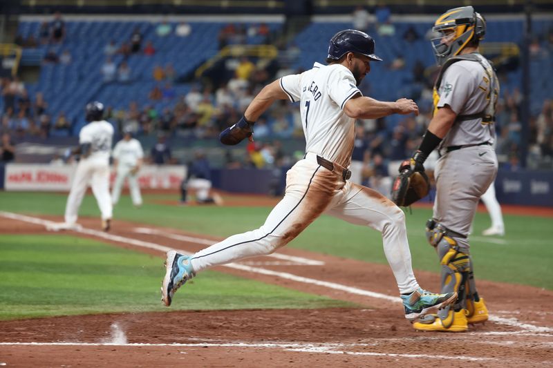 May 30, 2024; St. Petersburg, Florida, USA; Tampa Bay Rays shortstop Jose Caballero (7) scores a run as Oakland Athletics catcher Shea Langeliers (23) looks on during the tenth inning at Tropicana Field. Mandatory Credit: Kim Klement Neitzel-USA TODAY Sports