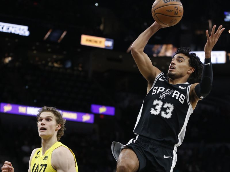 SAN ANTONIO, TX - DECEMBER 26:  Tre Jones #33 of the San Antonio Spurs shoots the ball against Lauri Markkanen #23 of the Utah Jazz late in the second half at AT&T Center on December 26, 2022 in San Antonio, Texas. NOTE TO USER: User expressly acknowledges and agrees that, by downloading and or using this photograph, User is consenting to terms and conditions of the Getty Images License Agreement. (Photo by Ronald Cortes/Getty Images)