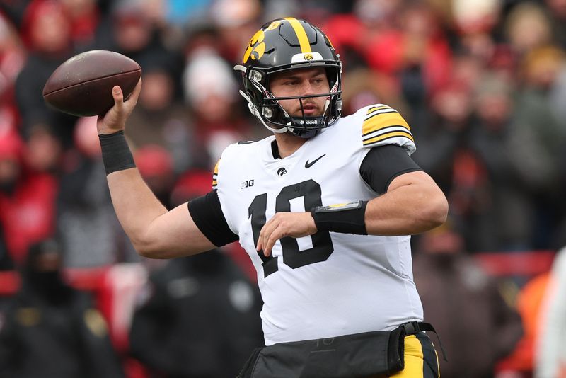 Nov 24, 2023; Lincoln, Nebraska, USA; Iowa Hawkeyes quarterback Deacon Hill (10) throws a pass against the Nebraska Cornhuskers at Memorial Stadium. Mandatory Credit: Reese Strickland-USA TODAY Sports