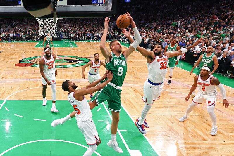 BOSTON, MASSACHUSETTS - MAY 07:  Kristaps Porzingis #8 of the Boston Celtics and Karl-Anthony Towns #32 of the New York Knicks battle for the rebound during the second quarter in Game Two of the Eastern Conference Second Round NBA Playoffs at TD Garden on May 07, 2025 in Boston, Massachusetts. NOTE TO USER: User expressly acknowledges and agrees that, by downloading and or using this photograph, User is consenting to the terms and conditions of the Getty Images License Agreement. (Photo by Maddie Meyer/Getty Images)