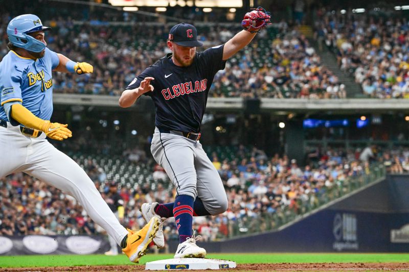 Aug 17, 2024; Milwaukee, Wisconsin, USA; Cleveland Guardians starting pitcher Tanner Bibee (28) beats Milwaukee Brewers center fielder Garrett Mitchell (5) to first base for the putout in the second inning at American Family Field. Mandatory Credit: Benny Sieu-USA TODAY Sports