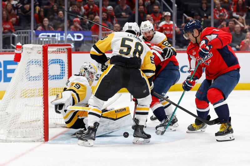 Apr 4, 2024; Washington, District of Columbia, USA; Pittsburgh Penguins goaltender Alex Nedeljkovic (39) makes a save on Washington Capitals left wing Alex Ovechkin (8) in the first period at Capital One Arena. Mandatory Credit: Geoff Burke-USA TODAY Sports