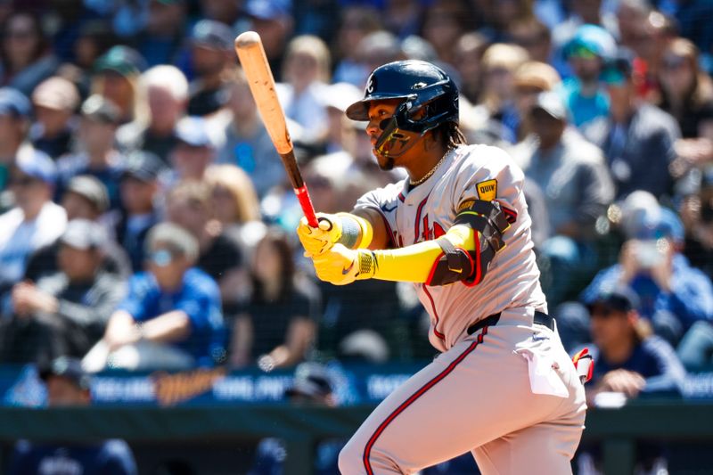 May 1, 2024; Seattle, Washington, USA; Atlanta Braves right fielder Ronald Acuna Jr. (13) hits a single against the Seattle Mariners during the third inning at T-Mobile Park. Mandatory Credit: Joe Nicholson-USA TODAY Sports