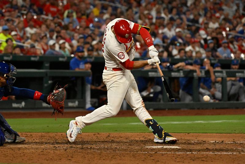 Jul 13, 2024; St. Louis, Missouri, USA; St. Louis Cardinals third baseman Nolan Arenado (28) hits a 2-run single against the Chicago Cubs during the eighth inning at Busch Stadium. Mandatory Credit: Jeff Le-USA TODAY Sports