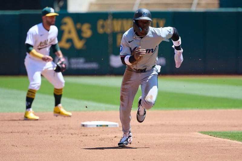 May 5, 2024; Oakland, California, USA; Miami Marlins outfielder Jazz Chisholm Jr. (2) runs towards third base against the Oakland Athletics during the first inning at Oakland-Alameda County Coliseum. Mandatory Credit: Robert Edwards-USA TODAY Sports