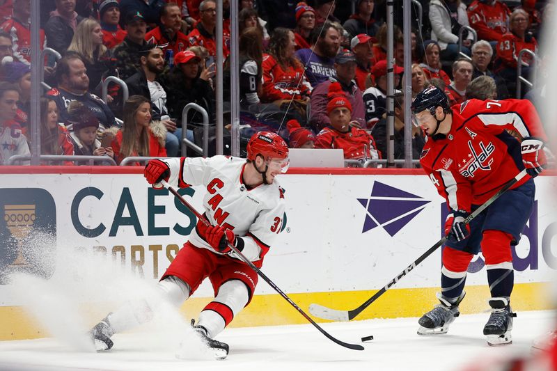 Jan 5, 2024; Washington, District of Columbia, USA; Carolina Hurricanes right wing Andrei Svechnikov (37) skates with the puck as Washington Capitals defenseman John Carlson (74) defends in the second period at Capital One Arena. Mandatory Credit: Geoff Burke-USA TODAY Sports