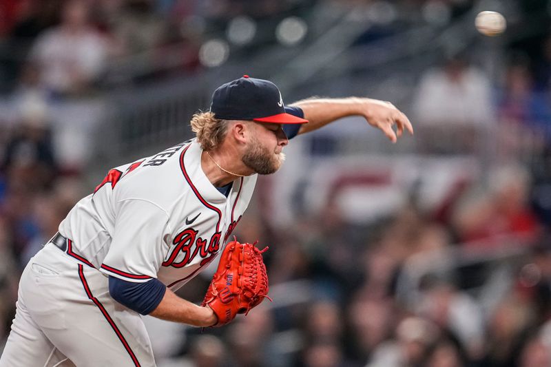 Apr 12, 2023; Cumberland, Georgia, USA; Atlanta Braves relief pitcher A.J. Minter (33) pitches against the Cincinnati Reds during the ninth inning at Truist Park. Mandatory Credit: Dale Zanine-USA TODAY Sports