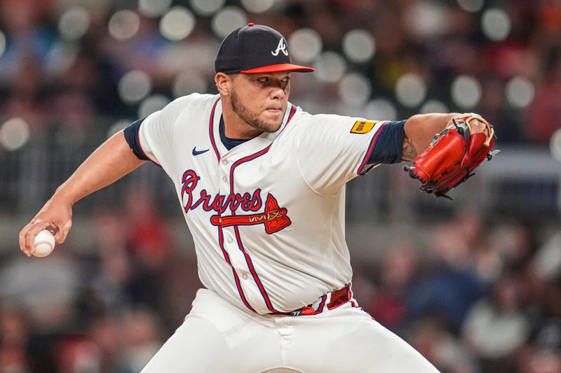 Sep 4, 2024; Cumberland, Georgia, USA; Atlanta Braves pitcher Joe Jimenez (77) pitches against the Colorado Rockies during the eighth inning at Truist Park. Mandatory Credit: Dale Zanine-Imagn Images