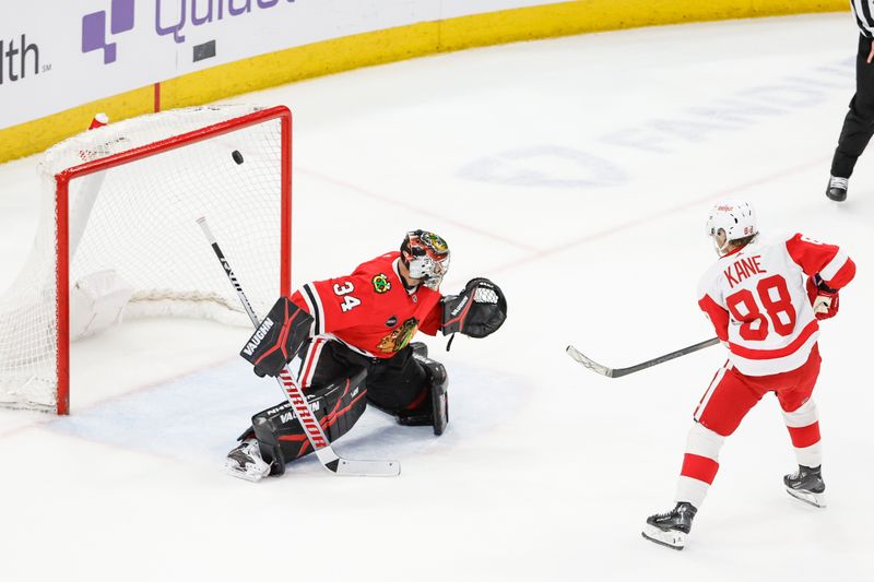 Feb 25, 2024; Chicago, Illinois, USA; Detroit Red Wings right wing Patrick Kane (88) scores game winning goal against Chicago Blackhawks goaltender Petr Mrazek (34) in overtime at United Center. Mandatory Credit: Kamil Krzaczynski-USA TODAY Sports