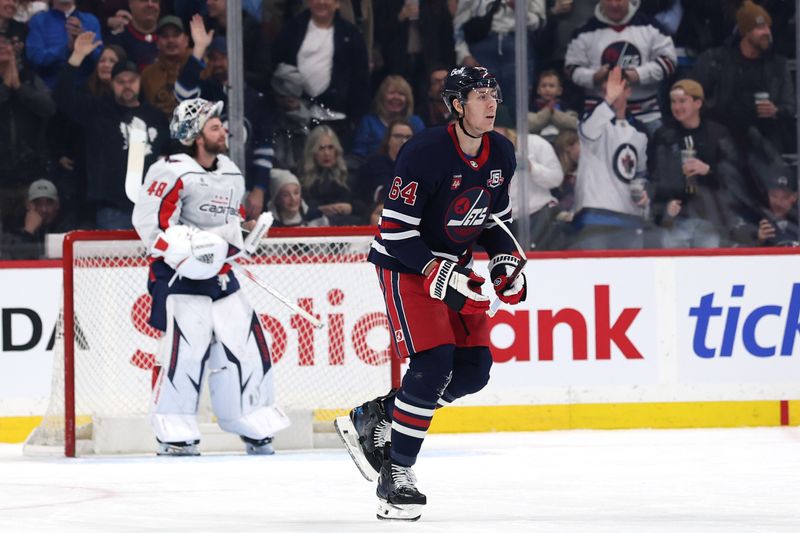 Dec 13, 2025; Winnipeg, Manitoba, CAN; Winnipeg Jets defenseman Logan Stanley (64) reacts after a goal on Washington Capitals goaltender Logan Thompson (48) in the first period at Canada Life Centre. Mandatory Credit: James Carey Lauder-Imagn Images