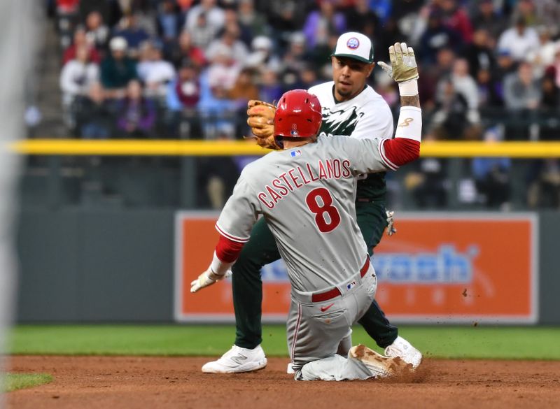 May 13, 2023; Denver, Colorado, USA; Philadelphia Phillies right fielder Nick Castellanos (8) is caught stealing as he is tagged out by Colorado Rockies second baseman Alan Trejo (13) in the fifth inning at Coors Field. Mandatory Credit: John Leyba-USA TODAY Sports