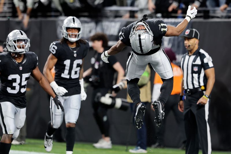 Las Vegas Raiders wide receiver Tre Tucker (11) celebrates after scoring a touchdown against the Los Angeles Chargers during the first half of an NFL football game, Thursday, Dec. 14, 2023, in Las Vegas. (AP Photo/Steve Marcus)